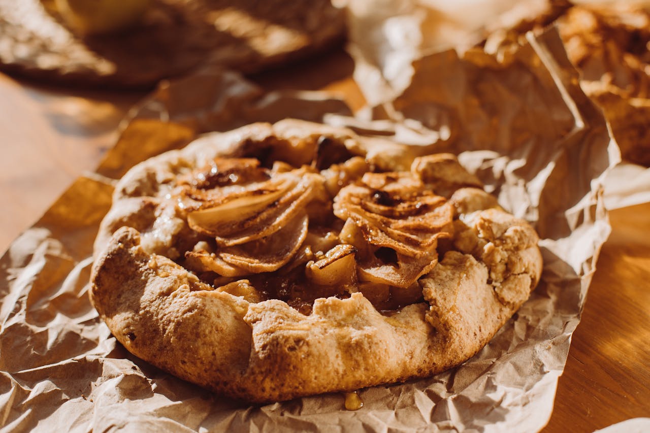 A delicious homemade apple galette on rustic brown paper, perfect for breakfast or dessert.